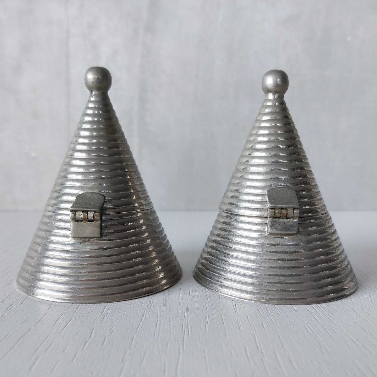 Pair of vintage conical ribbed cast metal tea light holders Aldo Rossi style