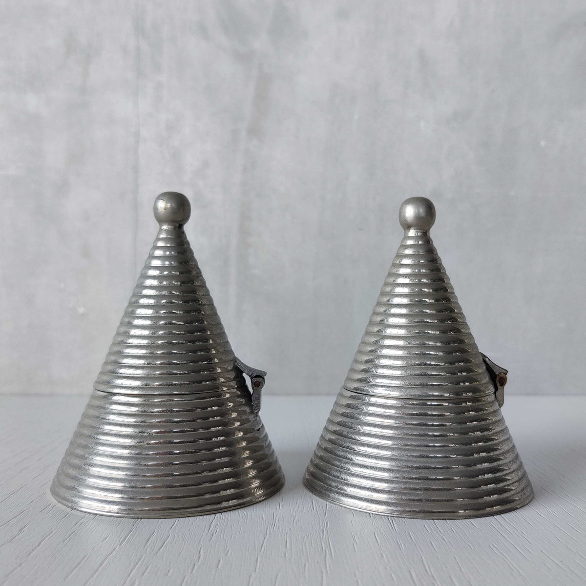 Pair of vintage conical ribbed cast metal tea light holders Aldo Rossi style