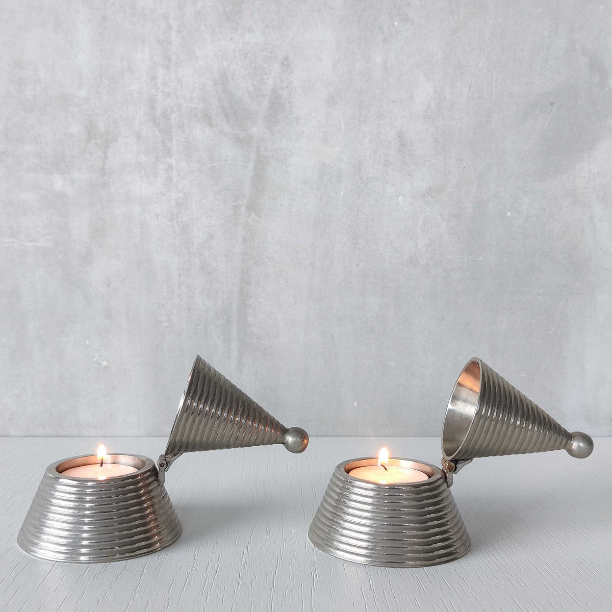 Pair of vintage conical ribbed cast metal tea light holders Aldo Rossi style