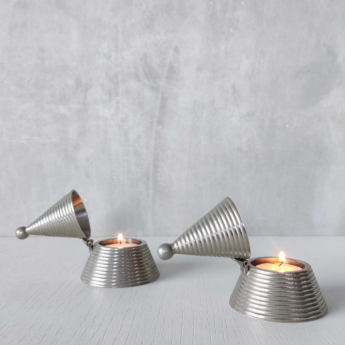 Pair of vintage conical ribbed cast metal tea light holders Aldo Rossi style