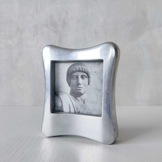 A 1990s chunky cast aluminium sculptural organic form photo frame