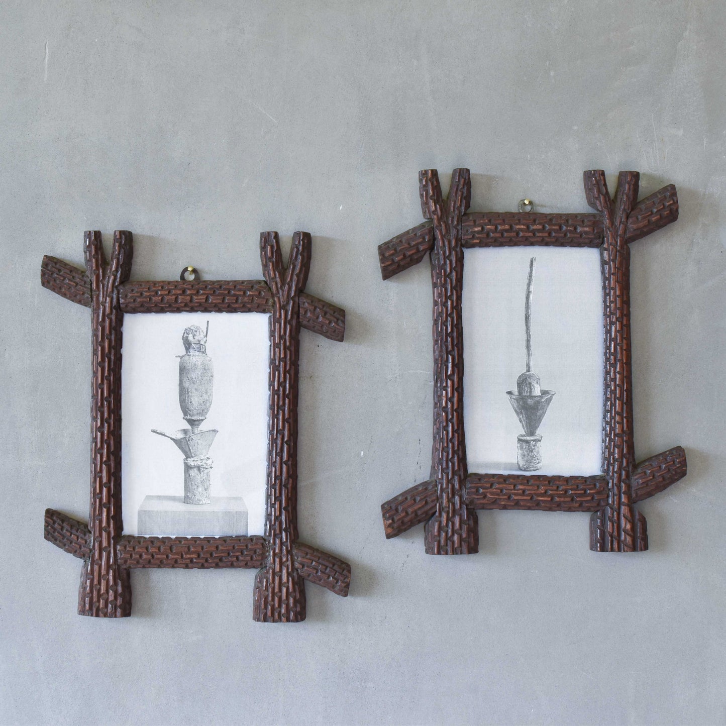 A pair of sculptural tramp folk art notched hand carved oak cross corner frames