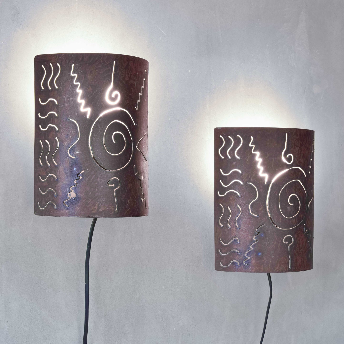 A pair of vintage torch cut steel abstract wall lights sconces