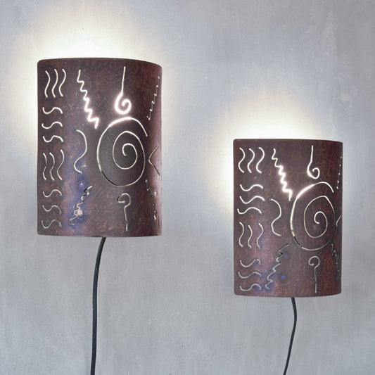 A pair of vintage torch cut steel abstract wall lights sconces
