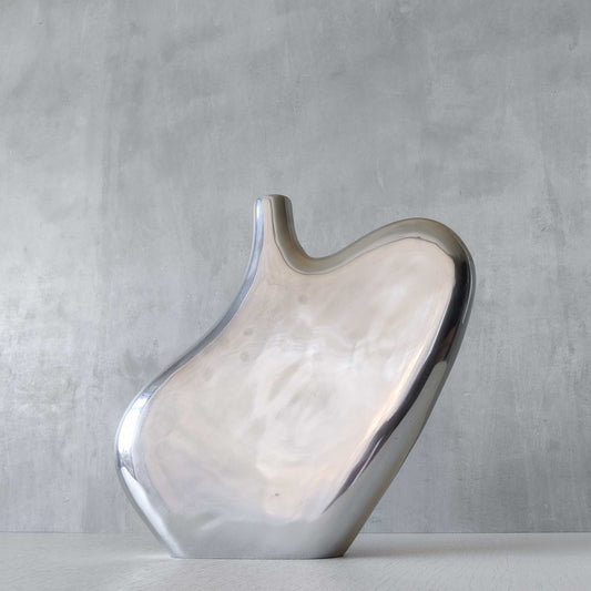 A large cast aluminium sculptural asymmetric vase