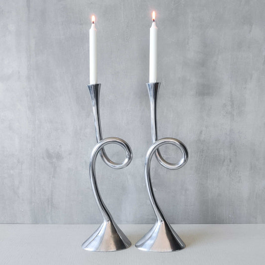 A pair of large vintage cast aluminium knotted loop candle holders