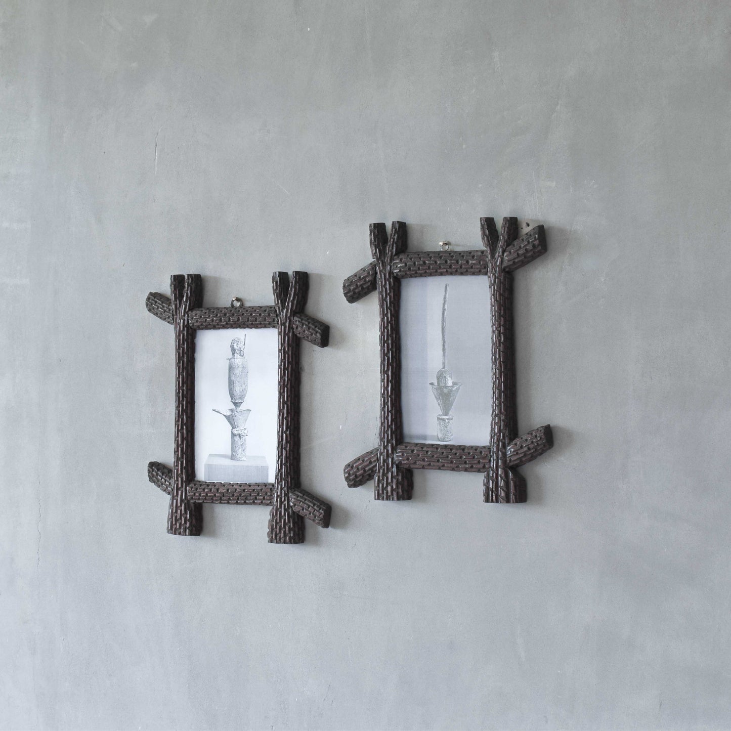 A pair of sculptural tramp folk art notched hand carved oak cross corner frames