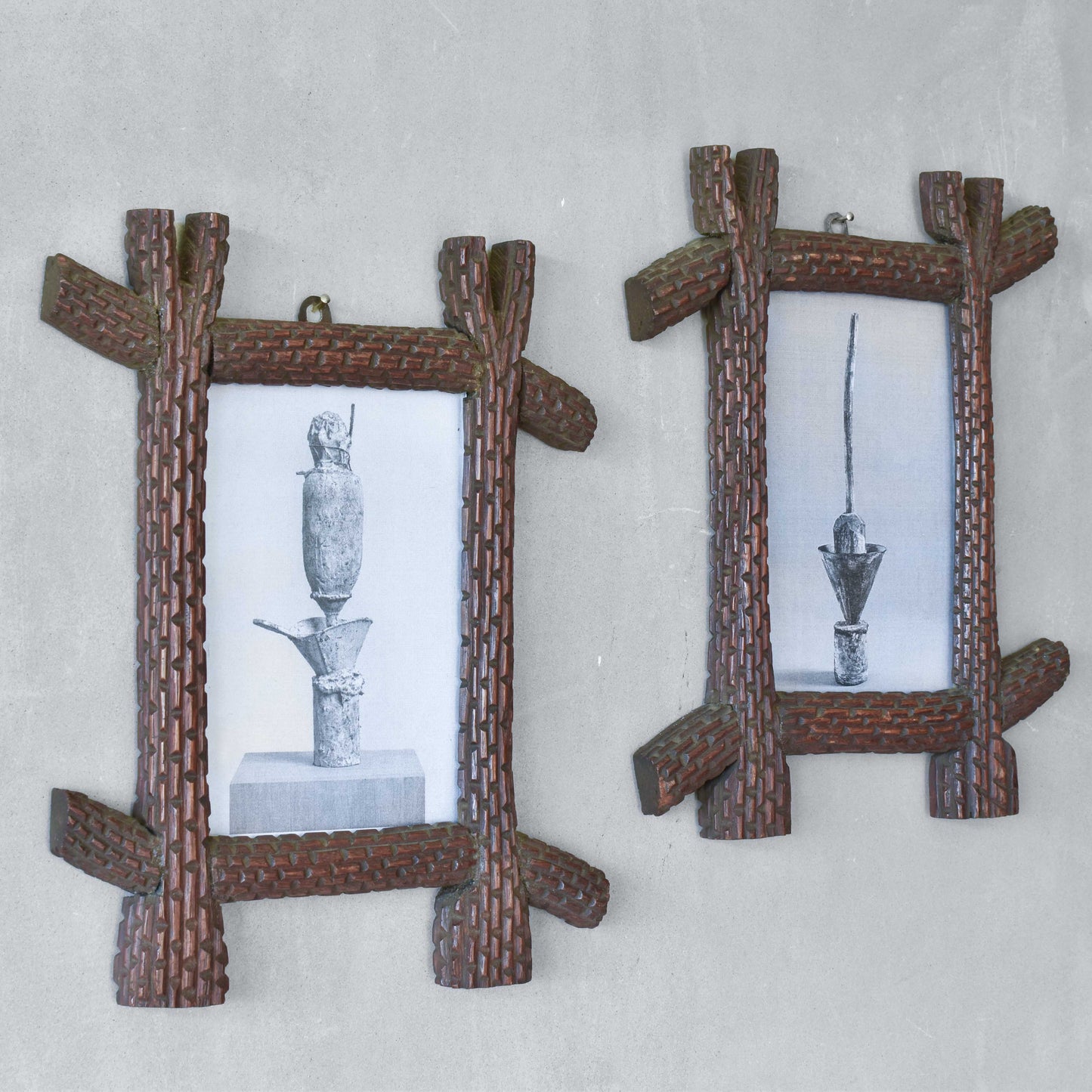 A pair of sculptural tramp folk art notched hand carved oak cross corner frames