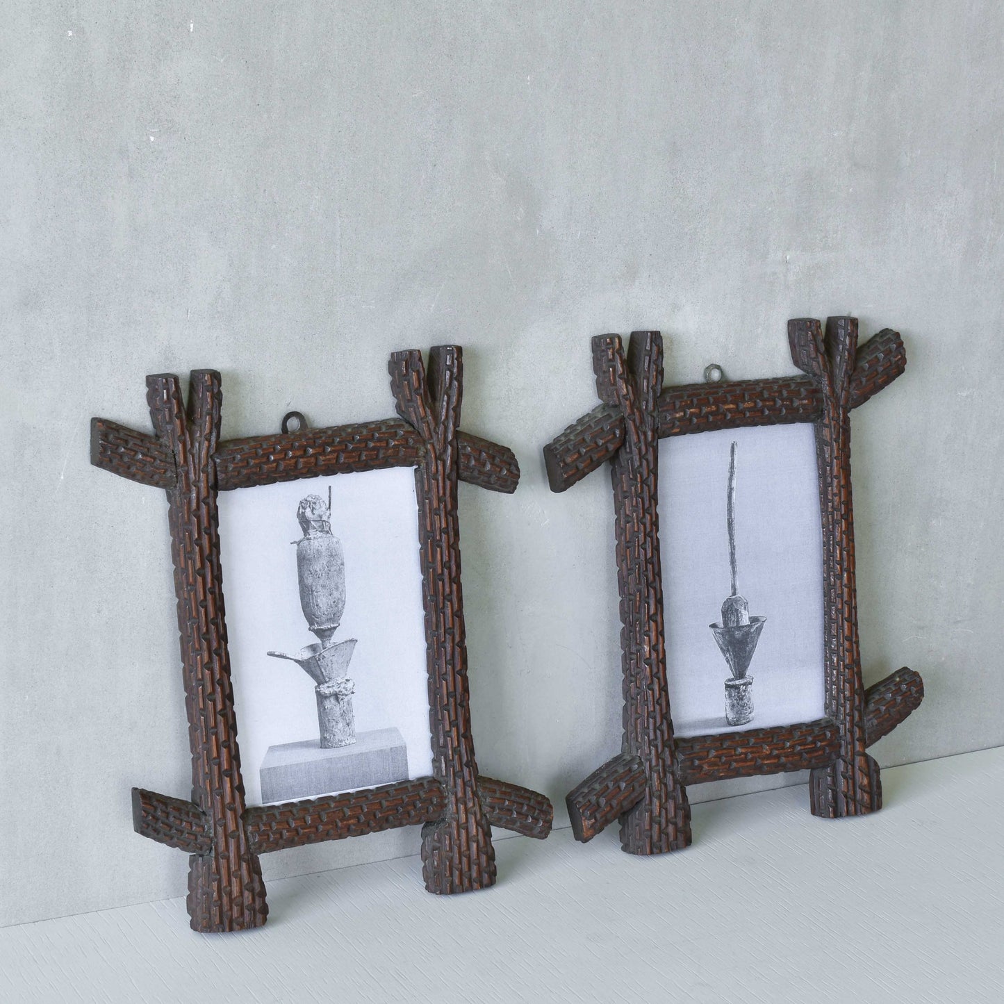 A pair of sculptural tramp folk art notched hand carved oak cross corner frames