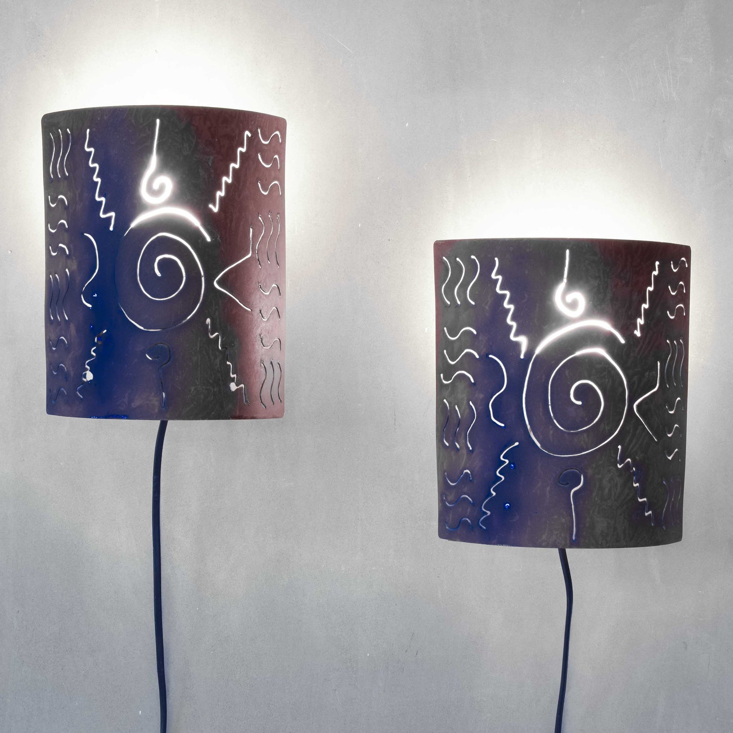A pair of vintage torch cut steel abstract wall lights sconces