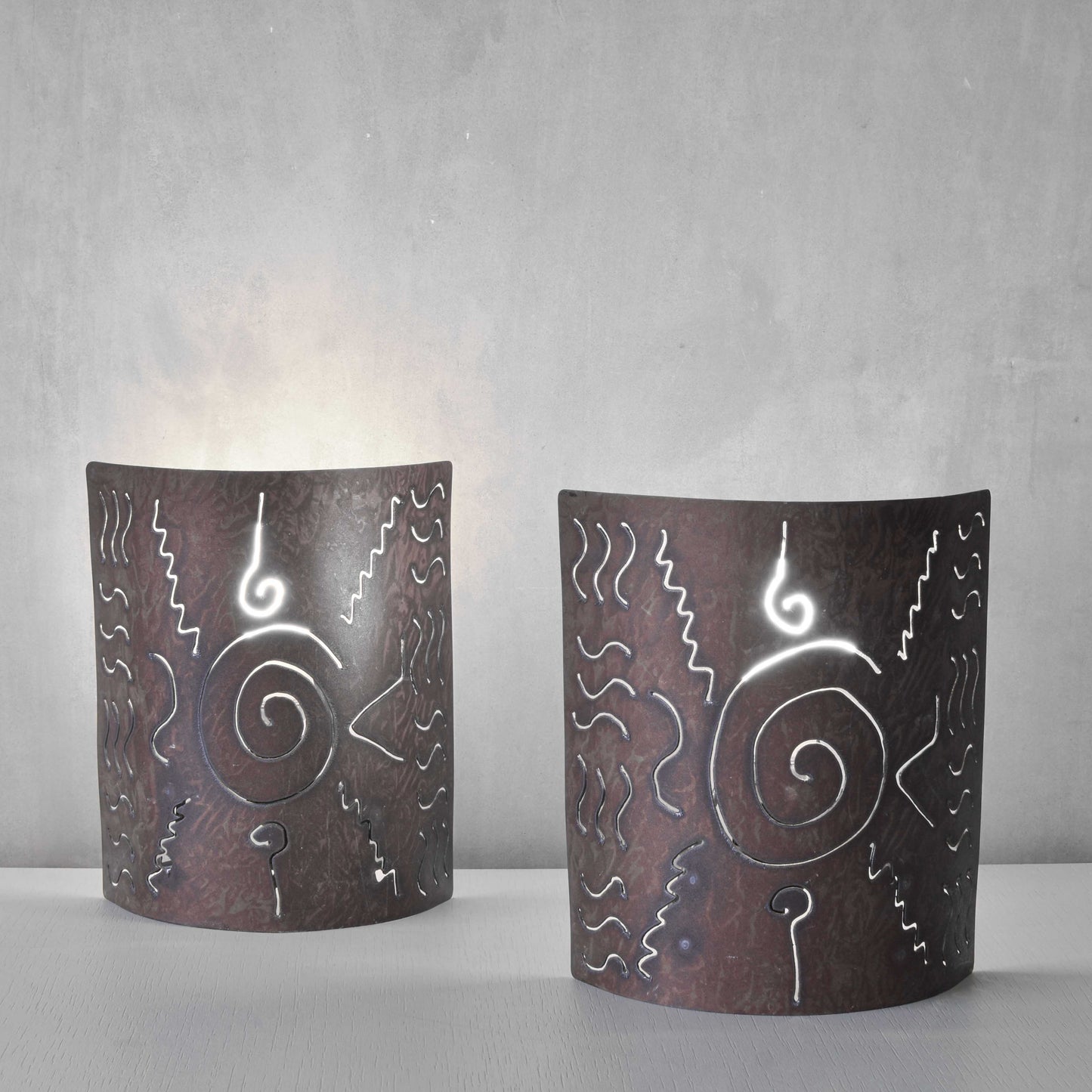 A pair of vintage torch cut steel abstract wall lights sconces