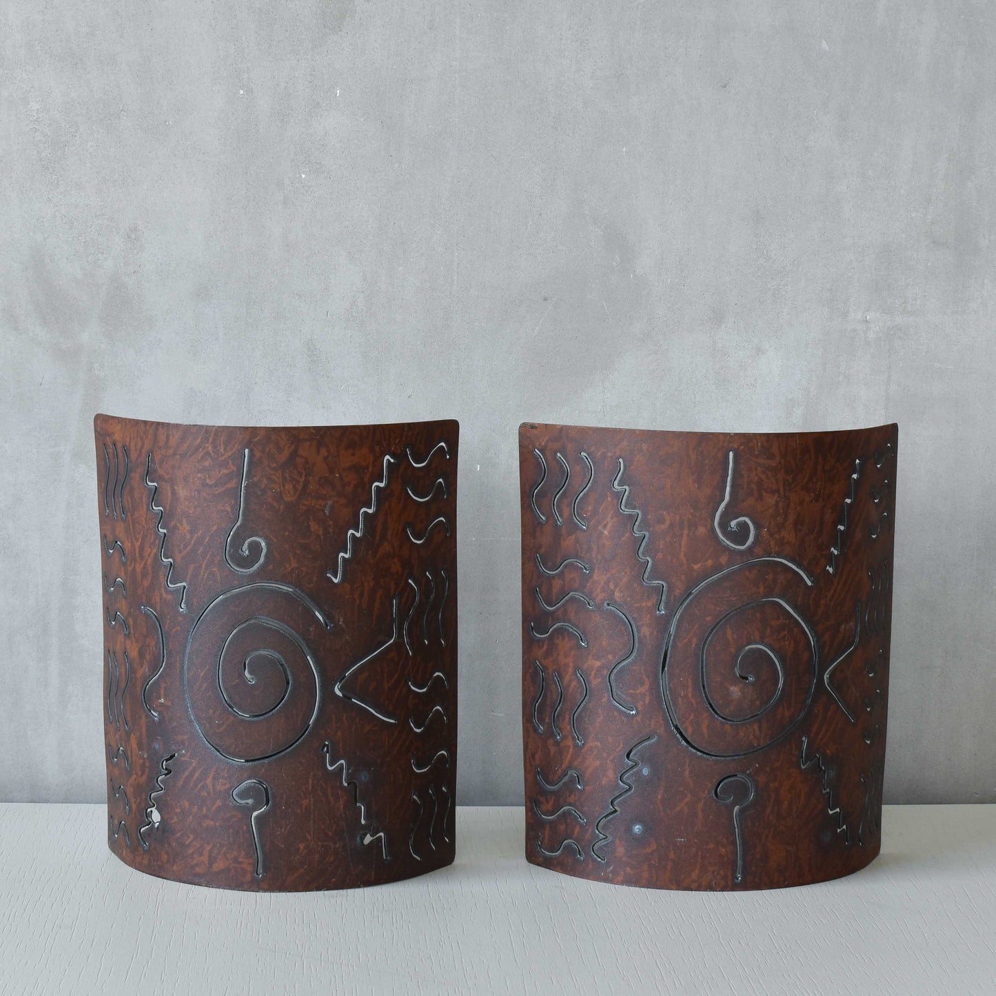 A pair of vintage torch cut steel abstract wall lights sconces