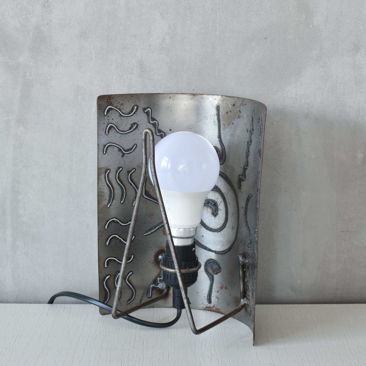 A pair of vintage torch cut steel abstract wall lights sconces