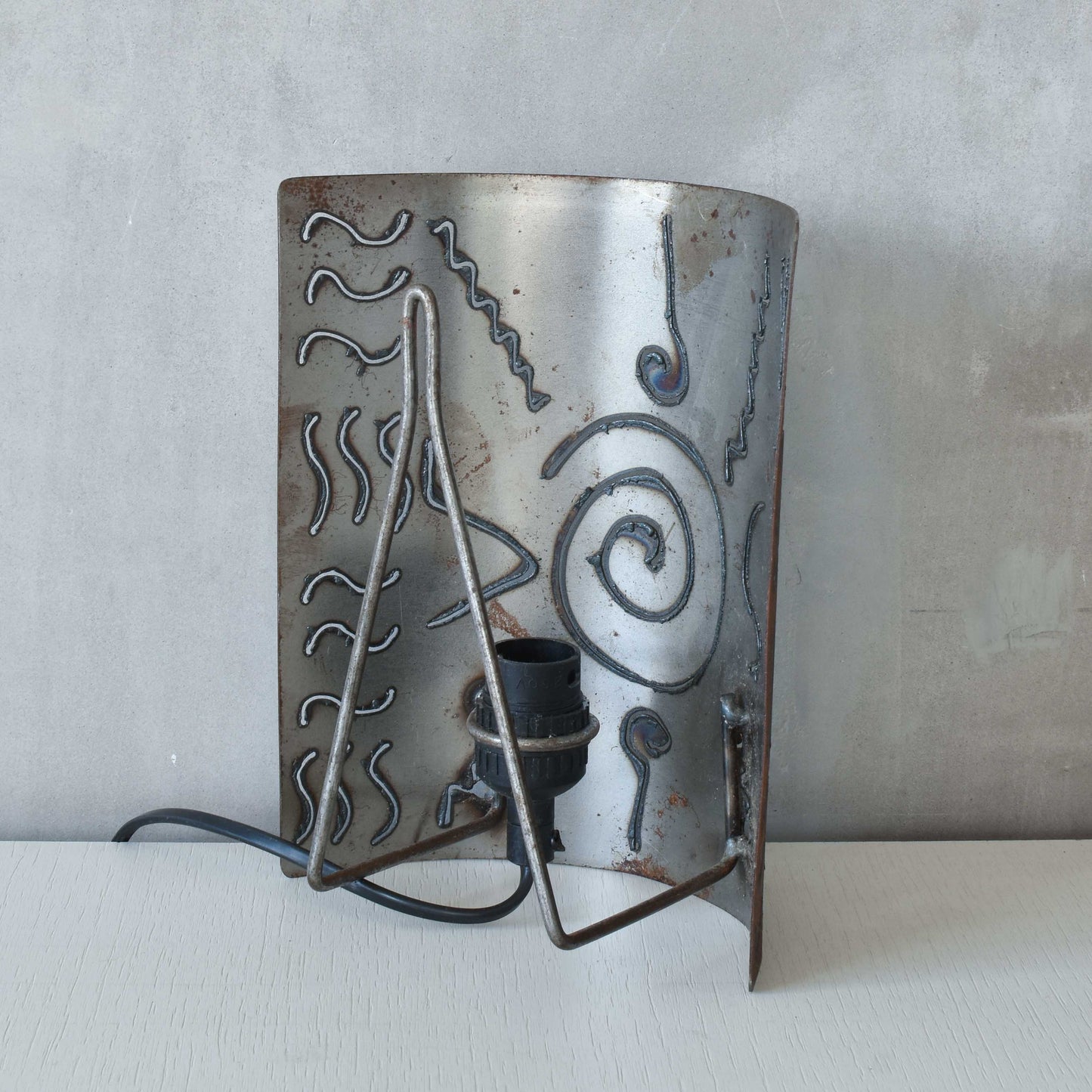 A pair of vintage torch cut steel abstract wall lights sconces