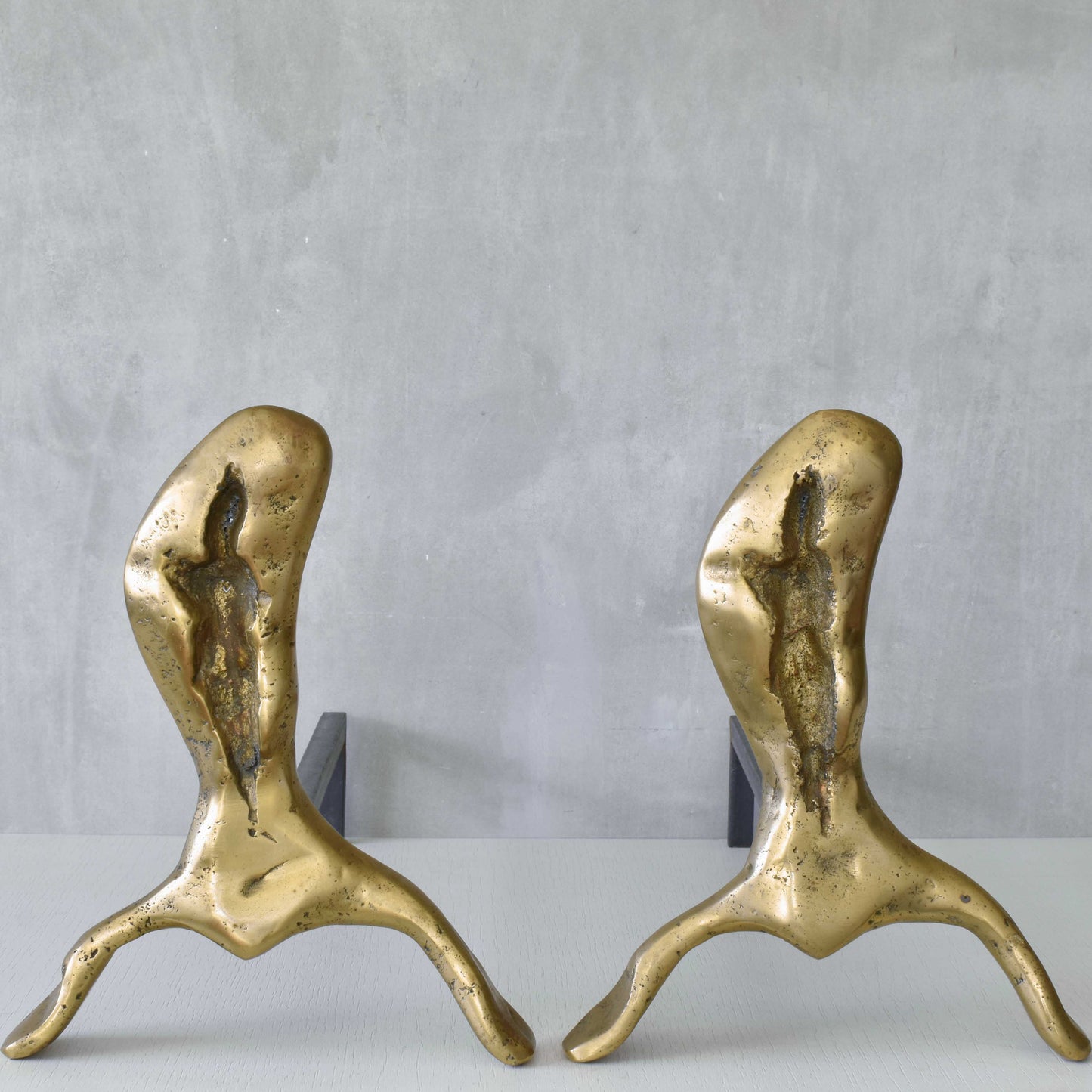 A David Marshall pair of organic brutalist sand cast brass sculptural fire dogs