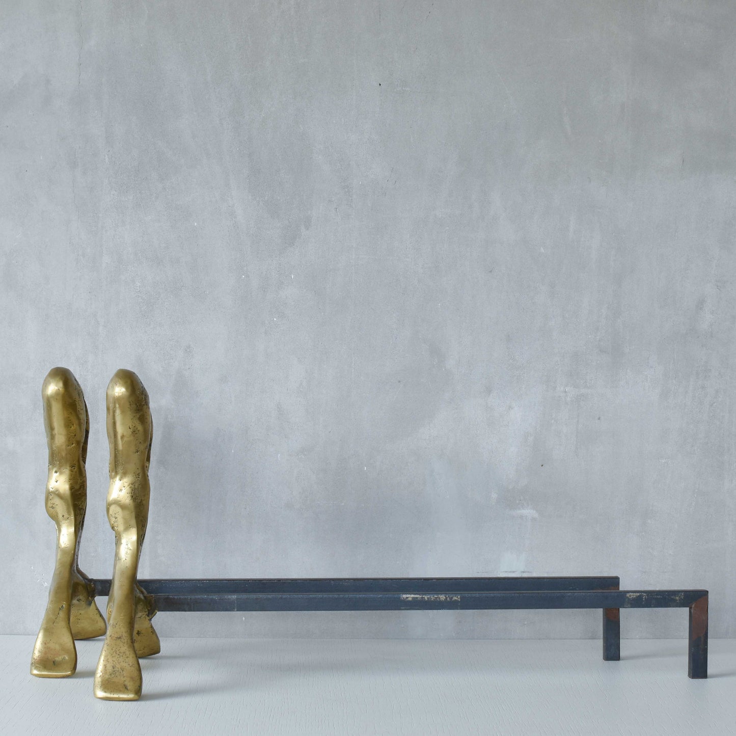 A David Marshall pair of organic brutalist sand cast brass sculptural fire dogs