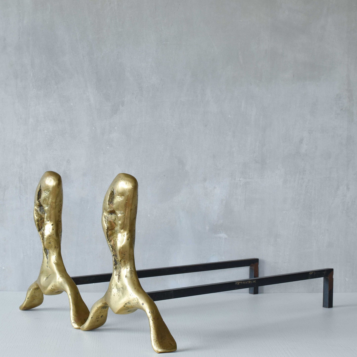 A David Marshall pair of organic brutalist sand cast brass sculptural fire dogs