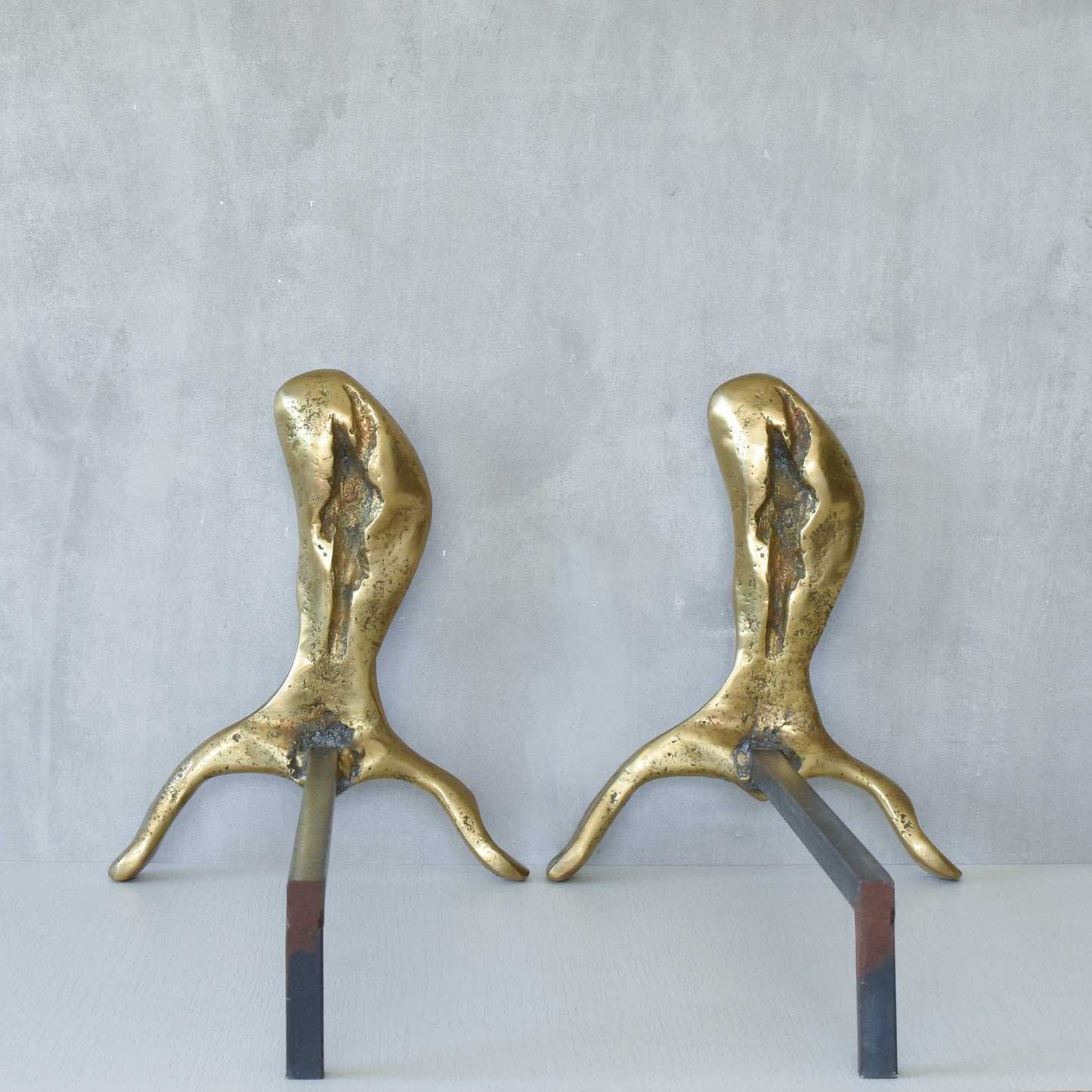 A David Marshall pair of organic brutalist sand cast brass sculptural fire dogs