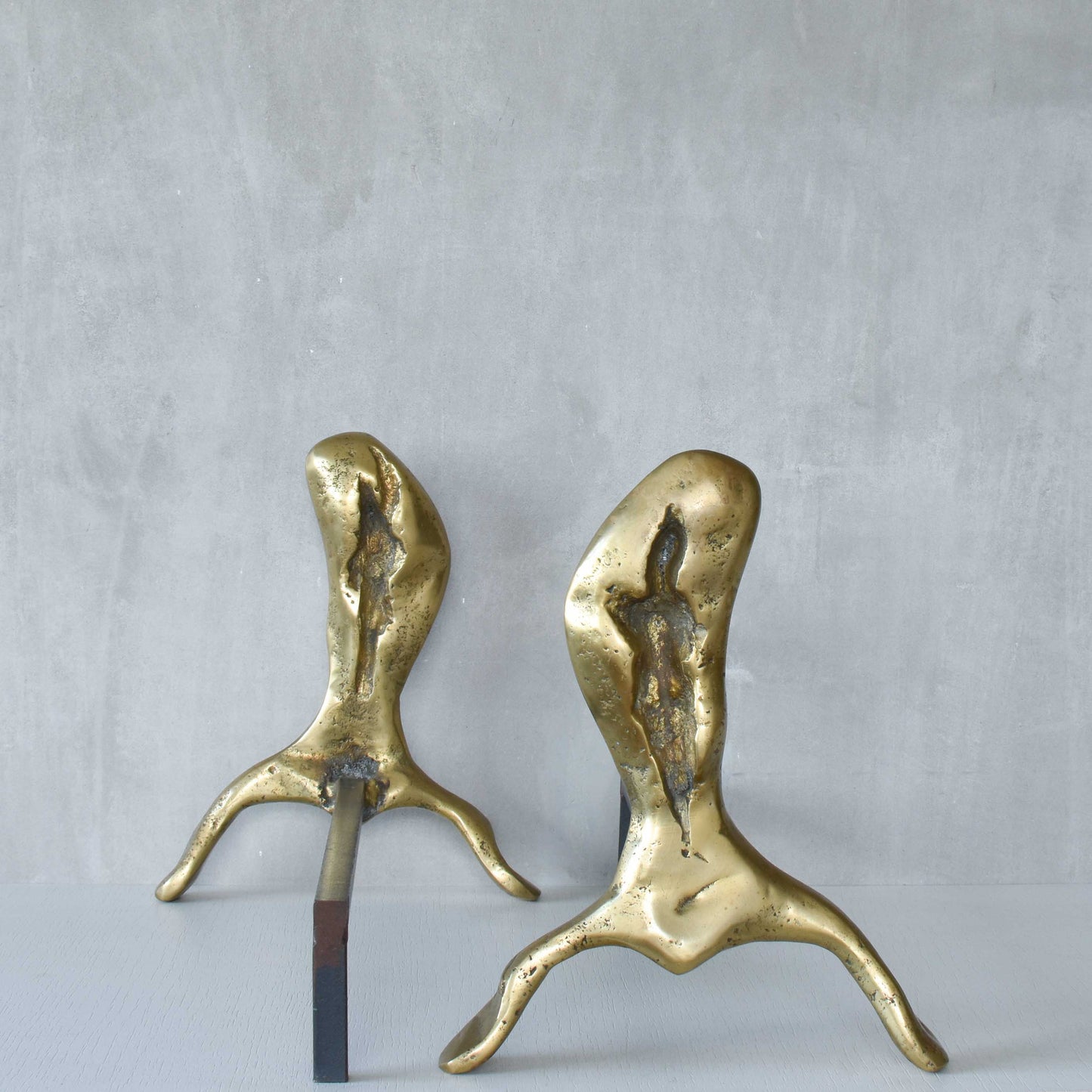 A David Marshall pair of organic brutalist sand cast brass sculptural fire dogs