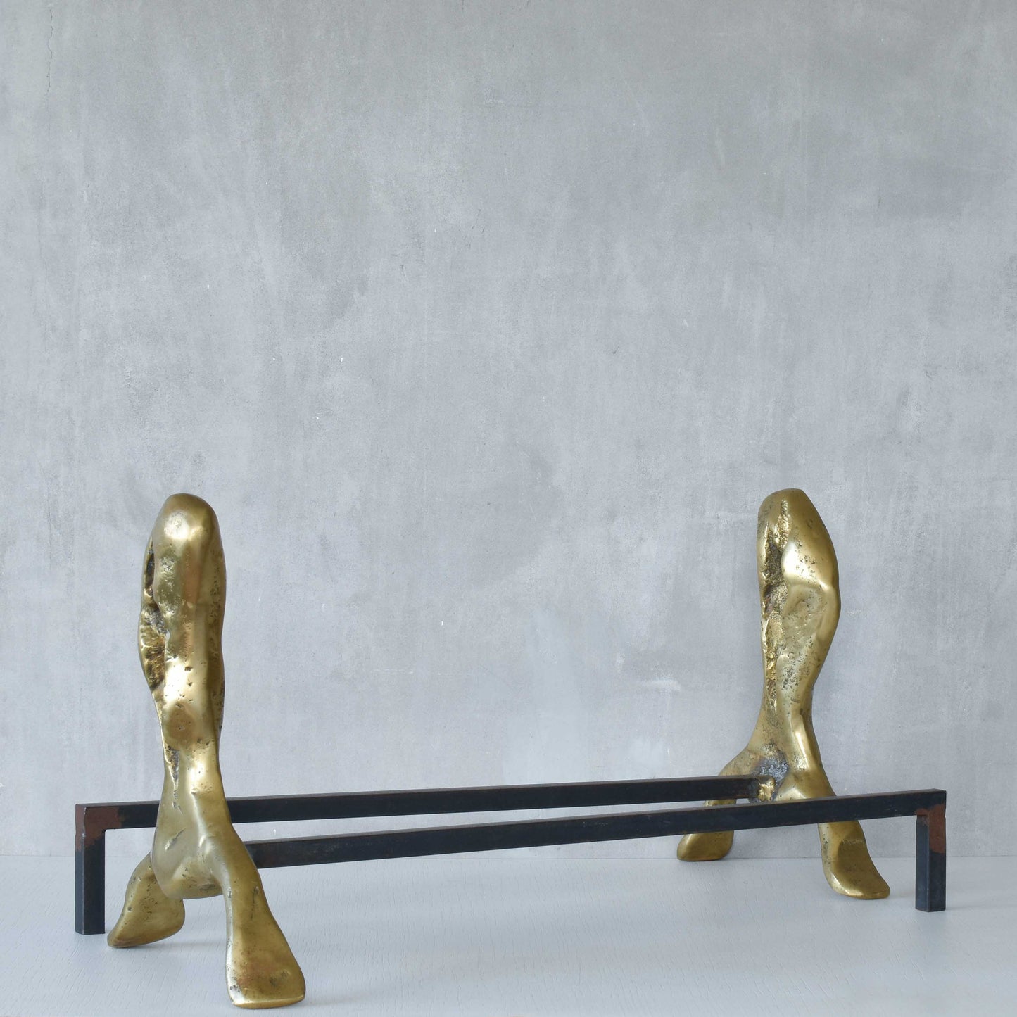 A David Marshall pair of organic brutalist sand cast brass sculptural fire dogs