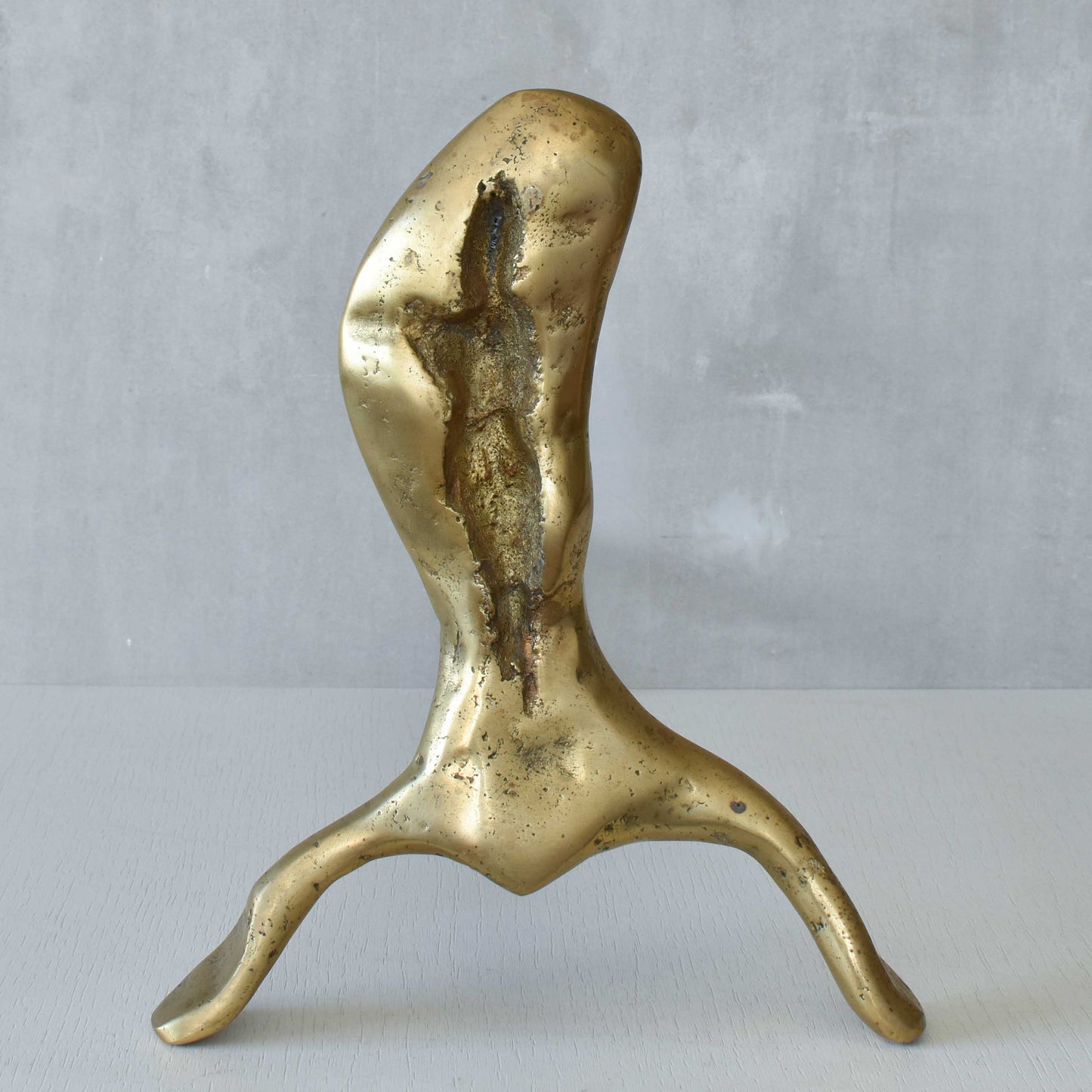 A David Marshall pair of organic brutalist sand cast brass sculptural fire dogs