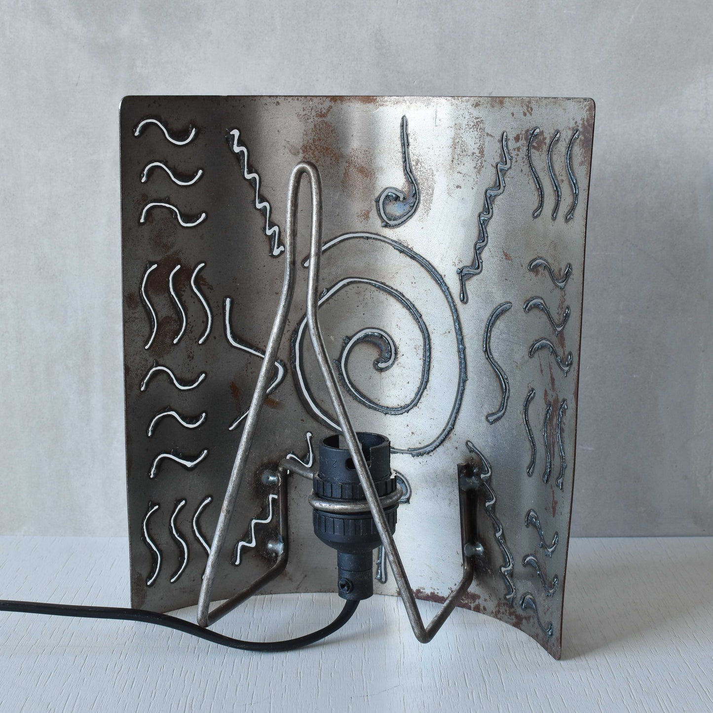 A pair of vintage torch cut steel abstract wall lights sconces