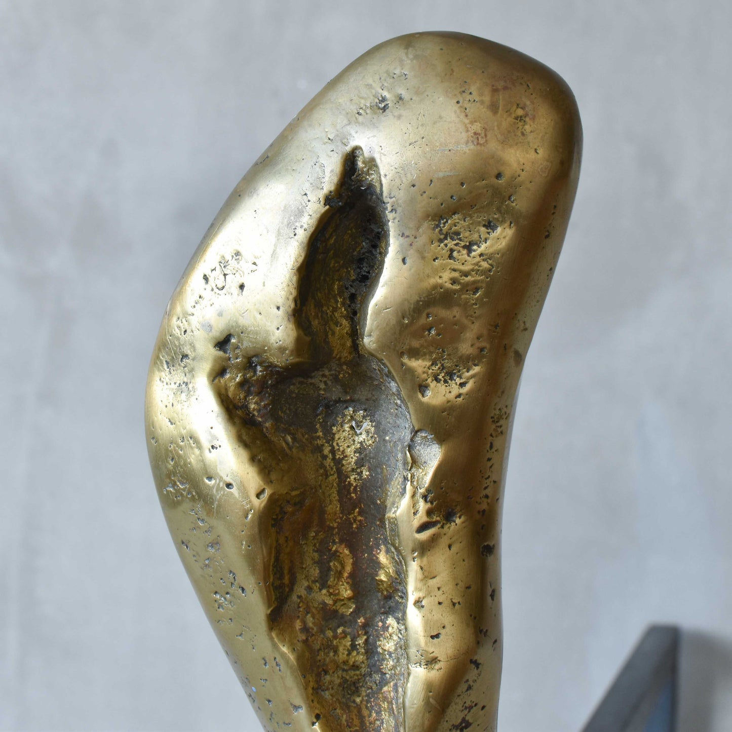 A David Marshall pair of organic brutalist sand cast brass sculptural fire dogs