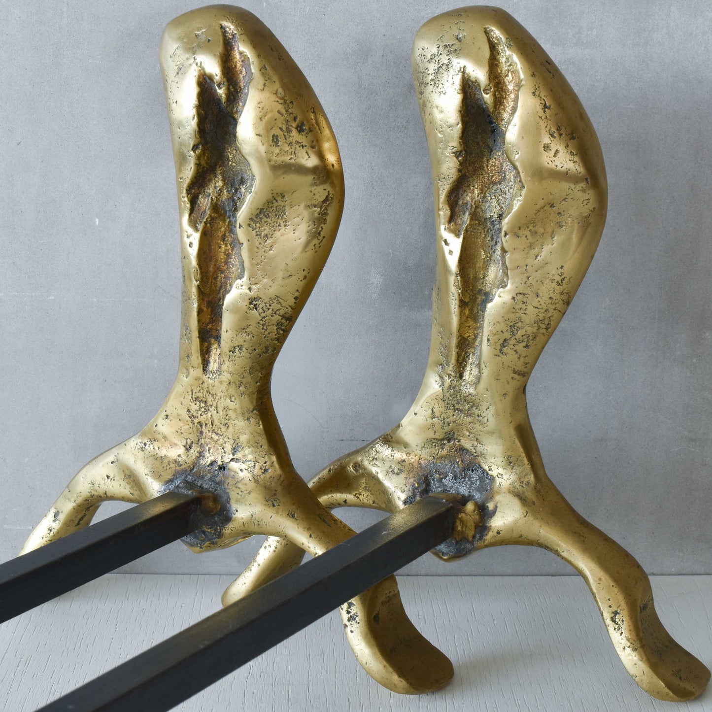 A David Marshall pair of organic brutalist sand cast brass sculptural fire dogs