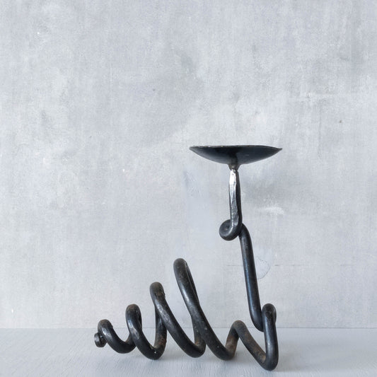A blacksmith made wrought iron sculptural candle holder