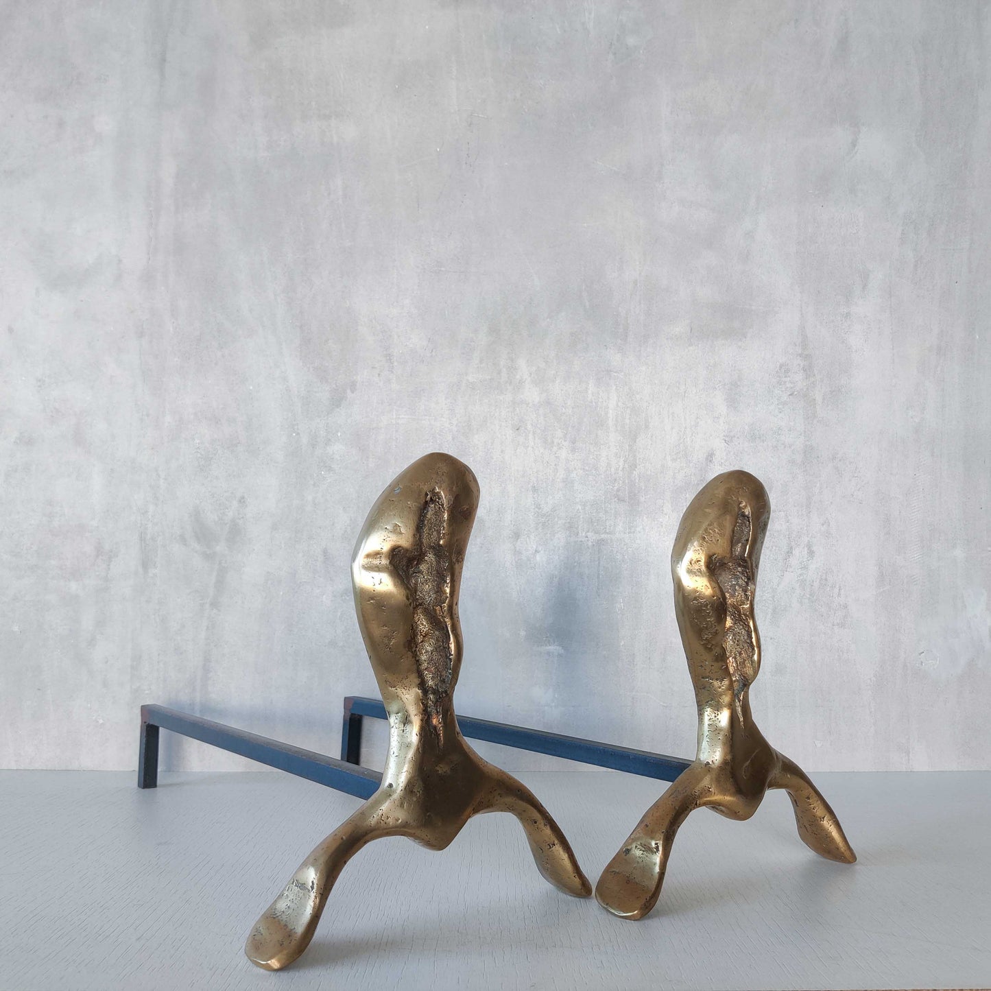 A David Marshall pair of organic brutalist sand cast brass sculptural fire dogs