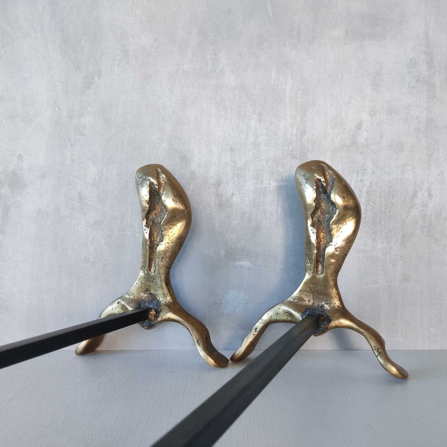 A David Marshall pair of organic brutalist sand cast brass sculptural fire dogs