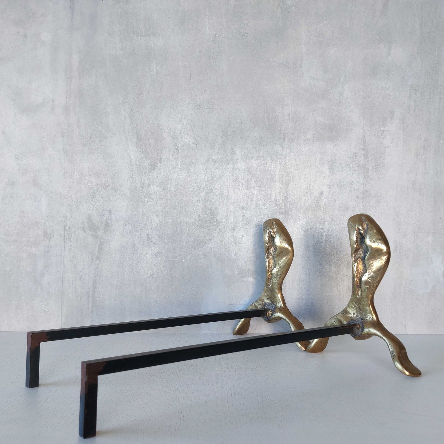 A David Marshall pair of organic brutalist sand cast brass sculptural fire dogs