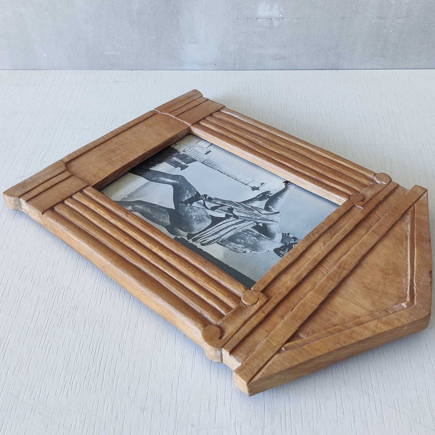 A hand carved hardwood neoclassical style photo frame