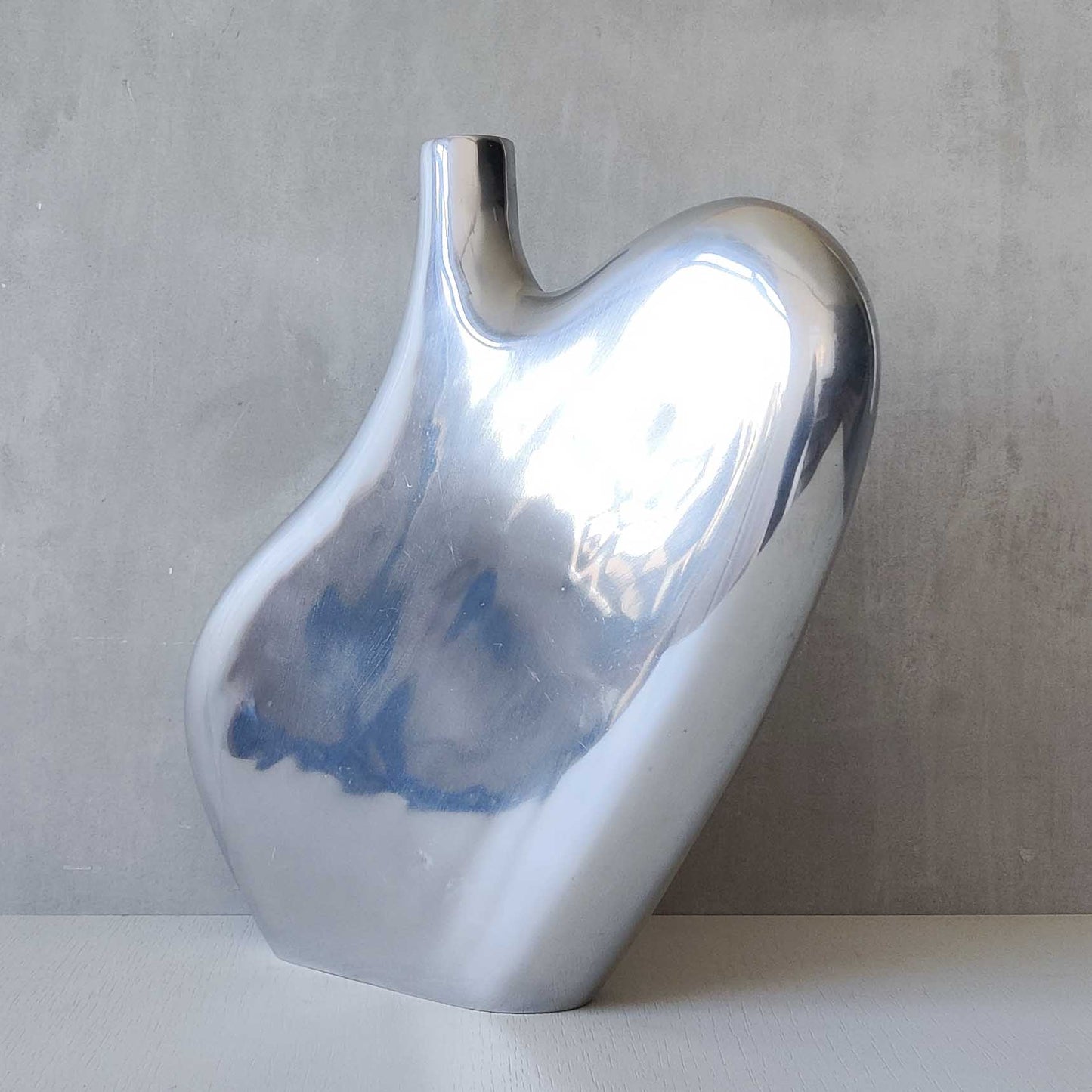 A large cast aluminium sculptural asymmetric vase