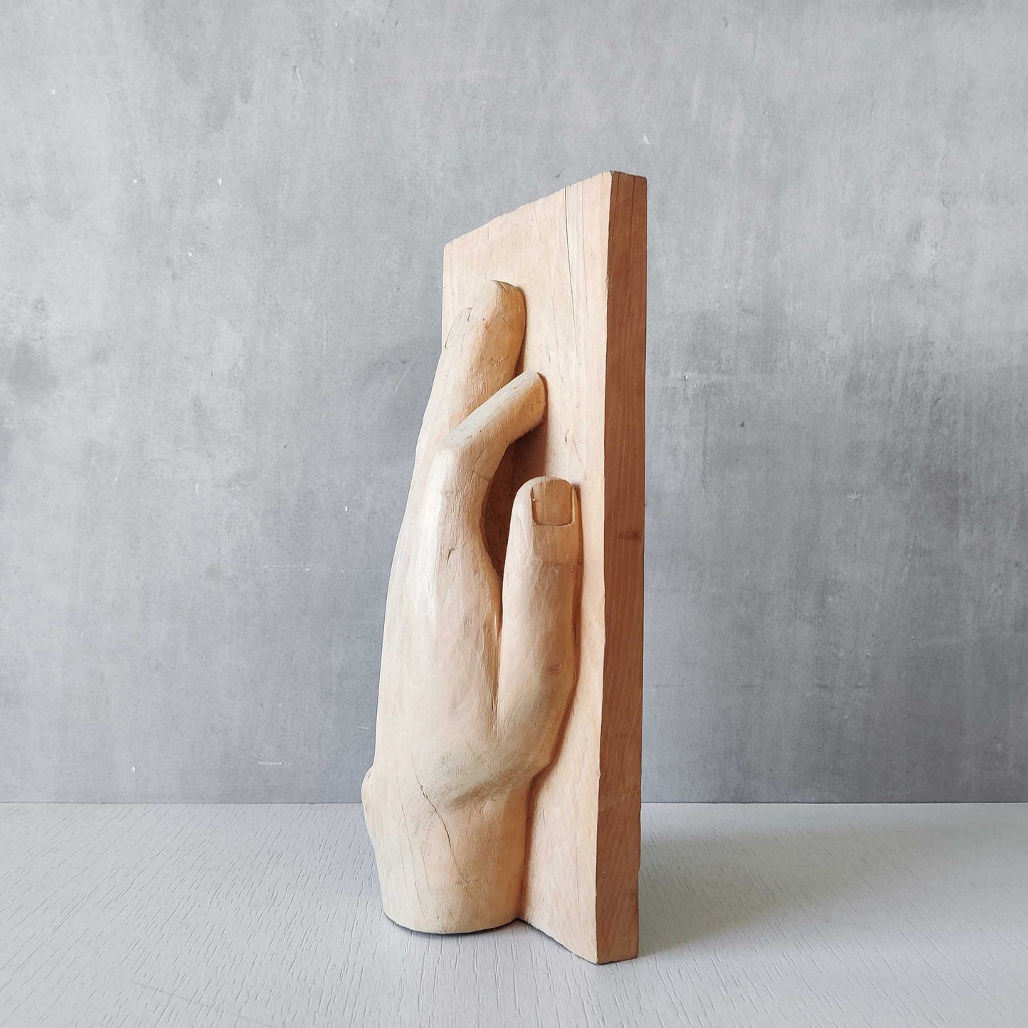 A carved tulip wood hand wall relief sculpture