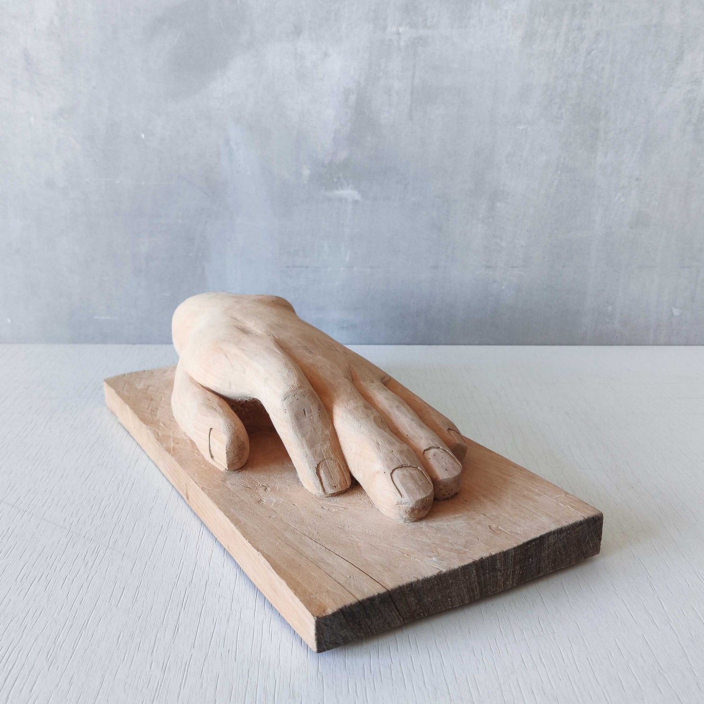 A carved tulip wood hand wall relief sculpture