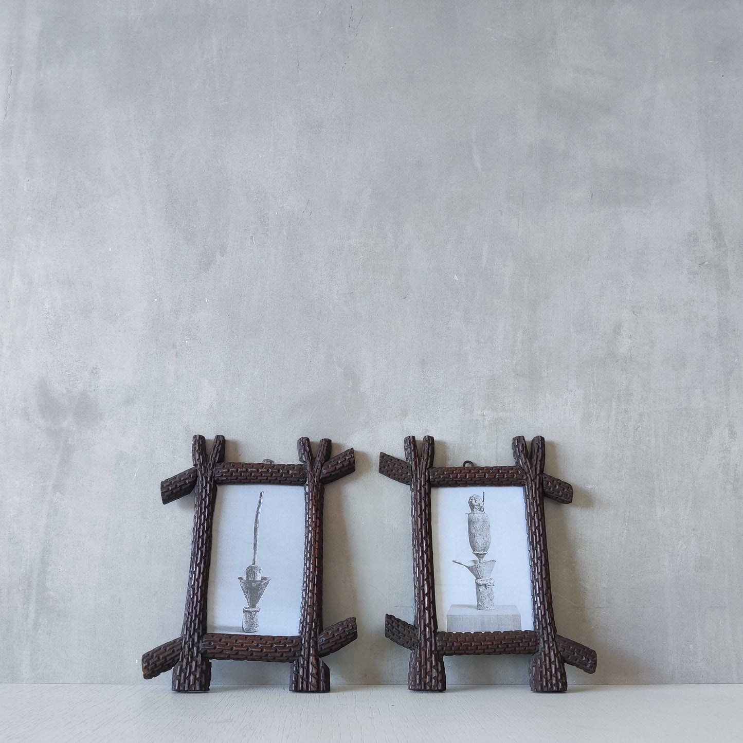 A pair of sculptural tramp folk art notched hand carved oak cross corner frames