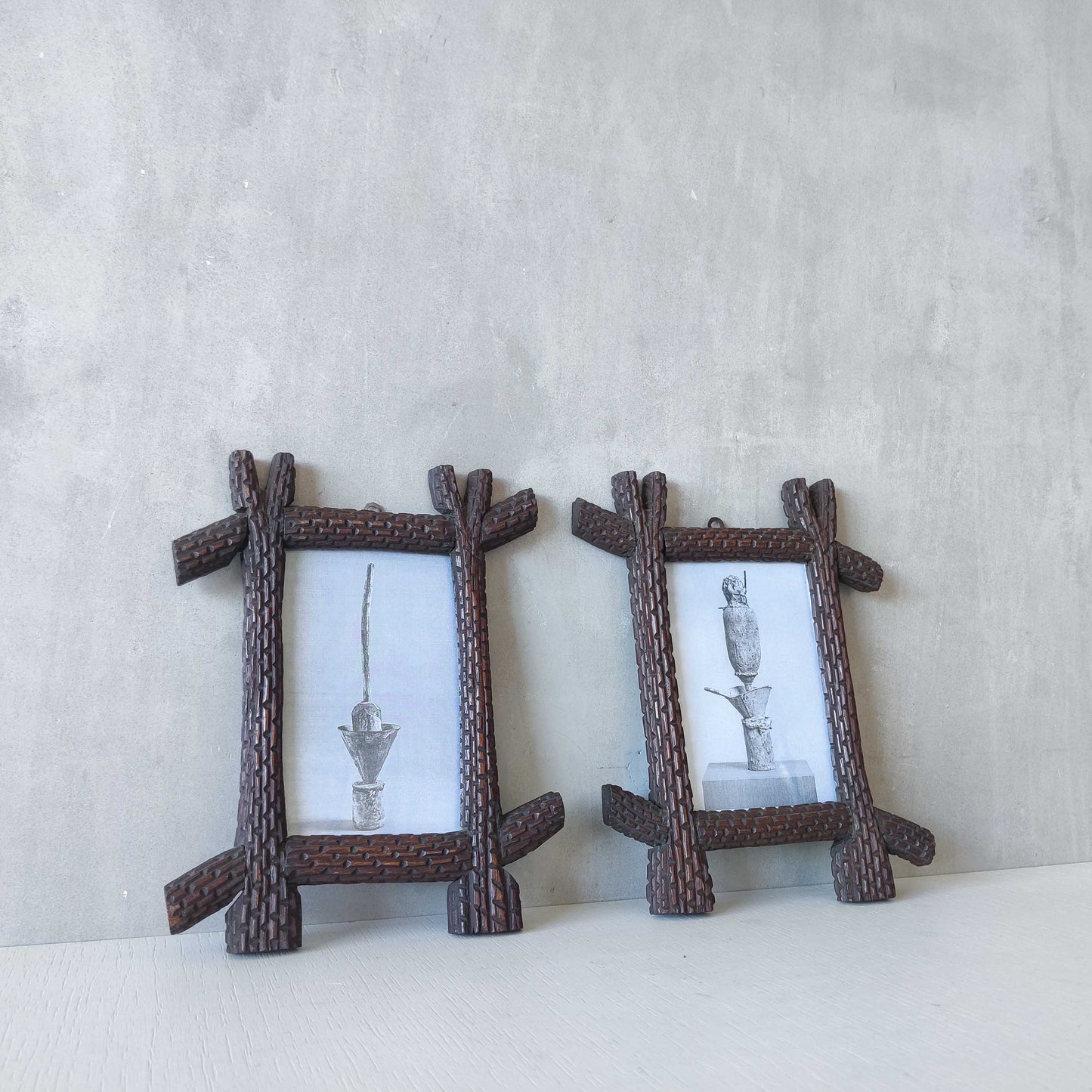 A pair of sculptural tramp folk art notched hand carved oak cross corner frames