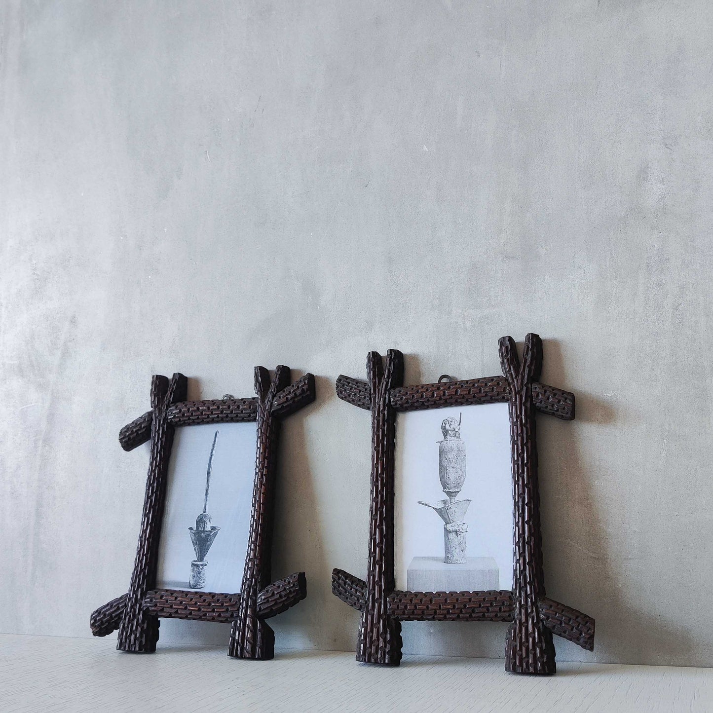 A pair of sculptural tramp folk art notched hand carved oak cross corner frames