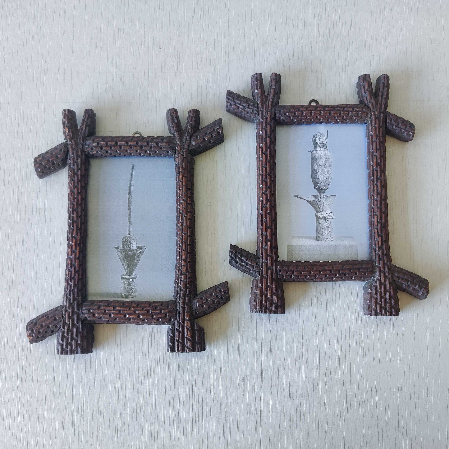 A pair of sculptural tramp folk art notched hand carved oak cross corner frames