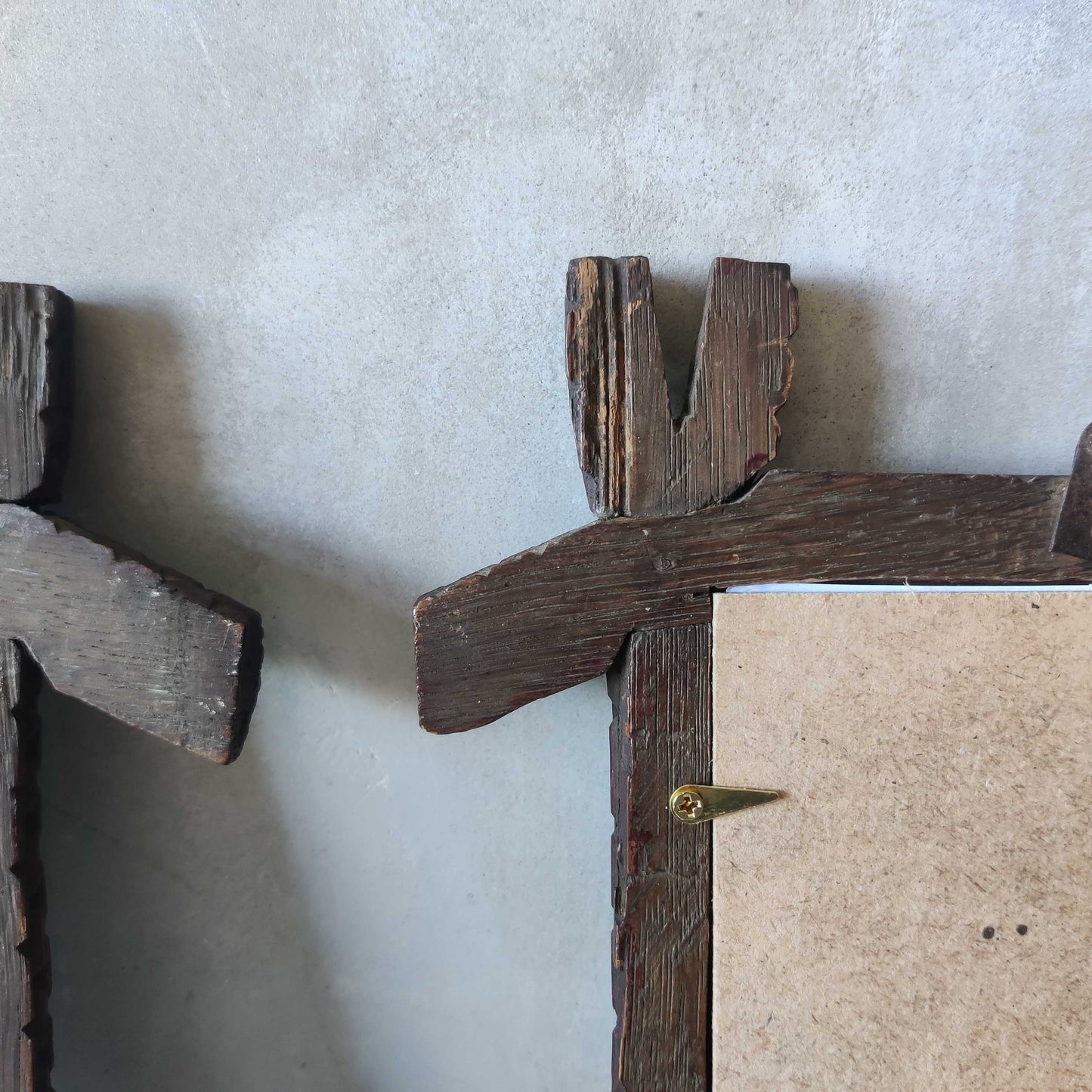 A pair of sculptural tramp folk art notched hand carved oak cross corner frames
