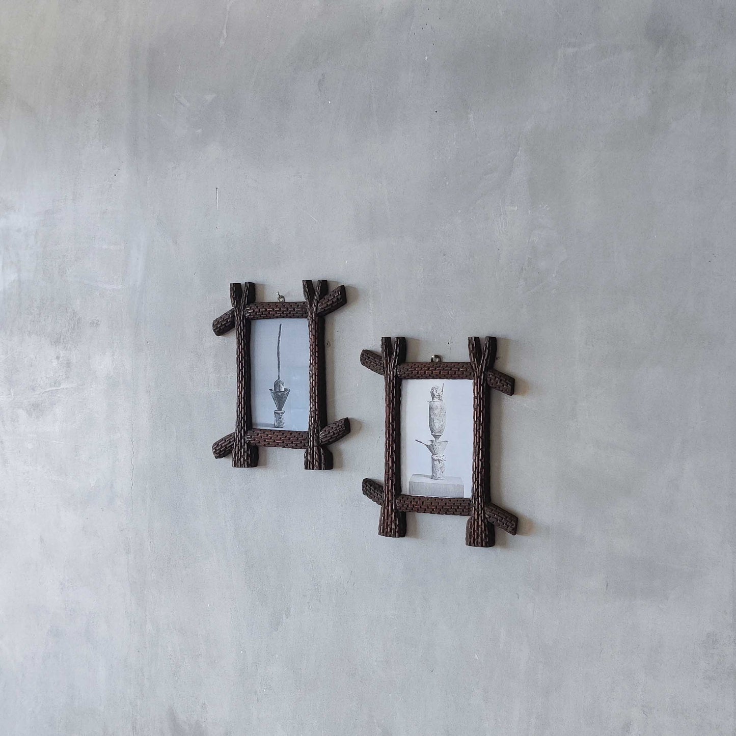 A pair of sculptural tramp folk art notched hand carved oak cross corner frames