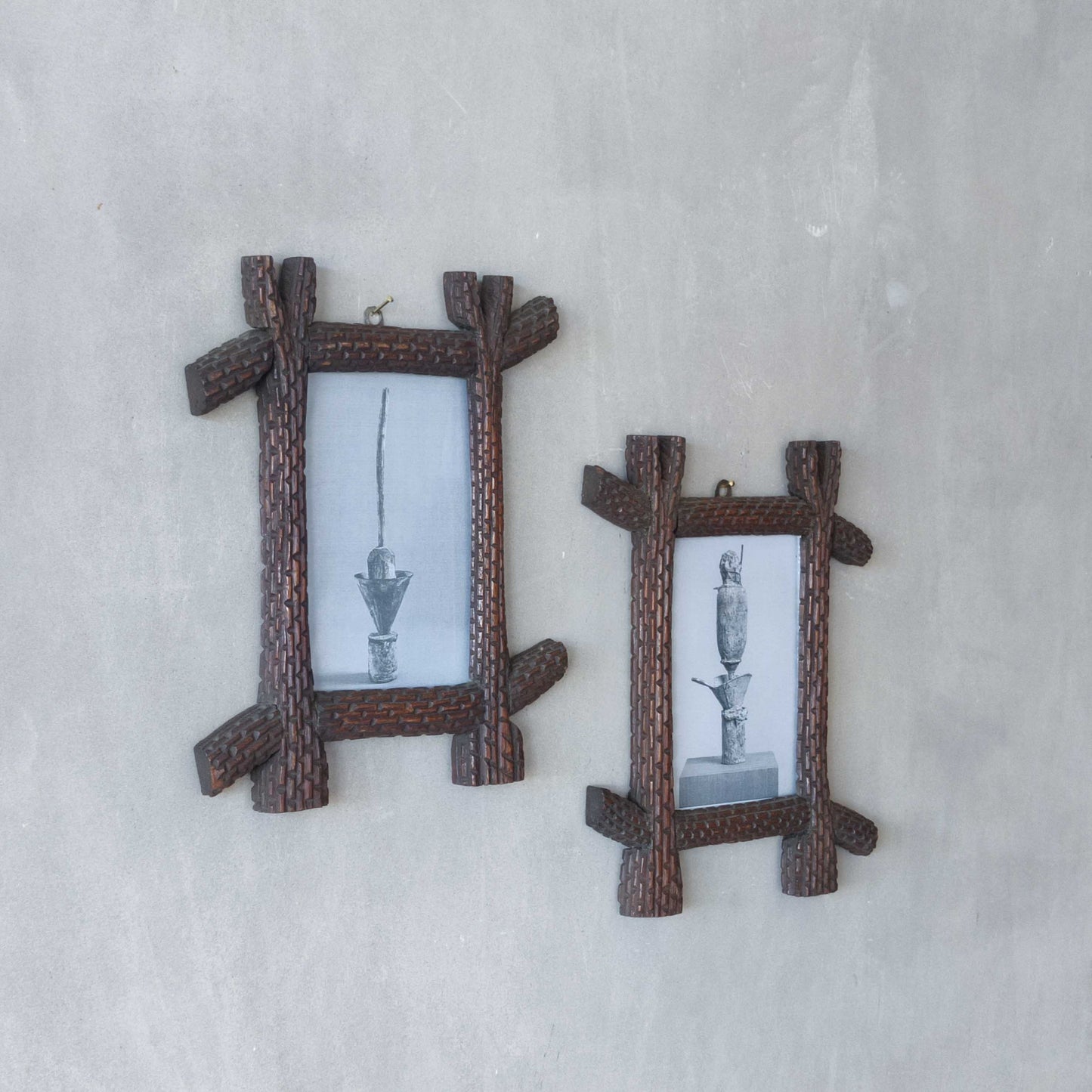 A pair of sculptural tramp folk art notched hand carved oak cross corner frames
