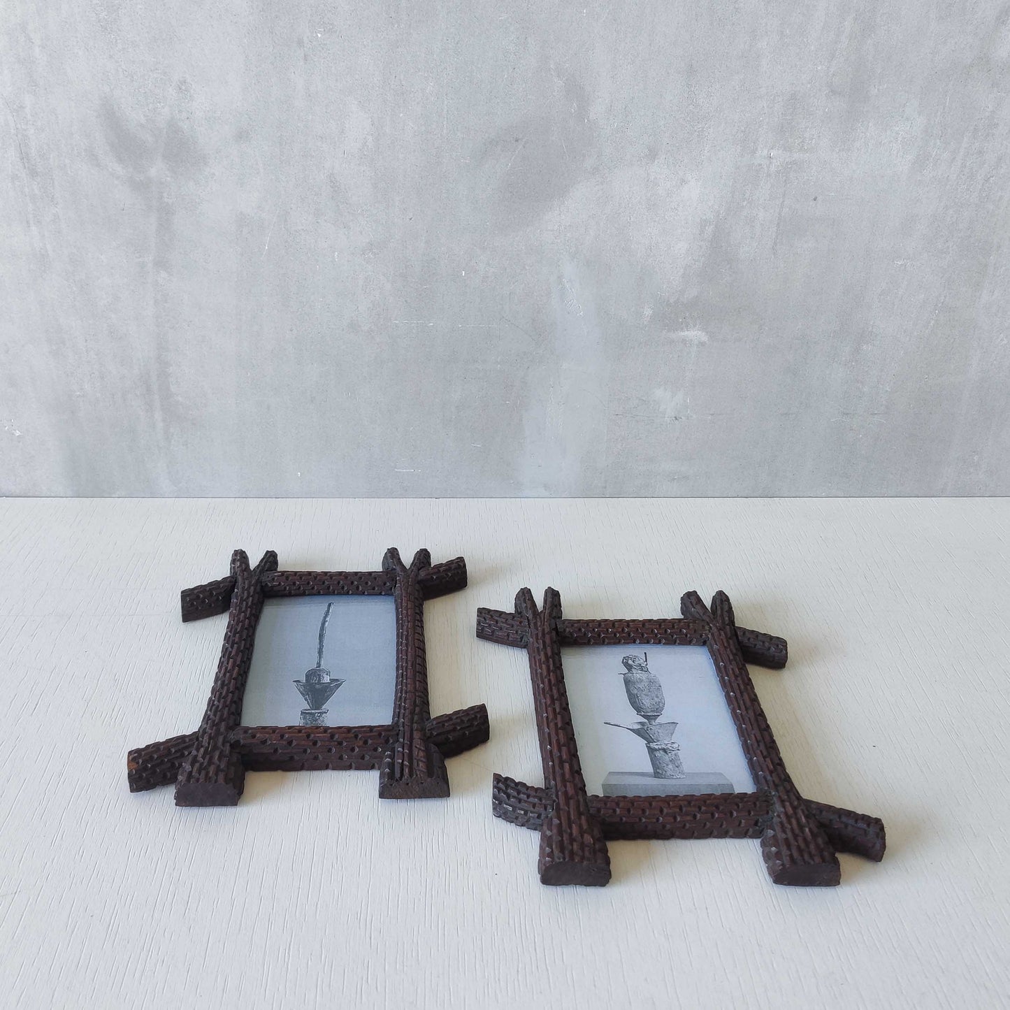A pair of sculptural tramp folk art notched hand carved oak cross corner frames