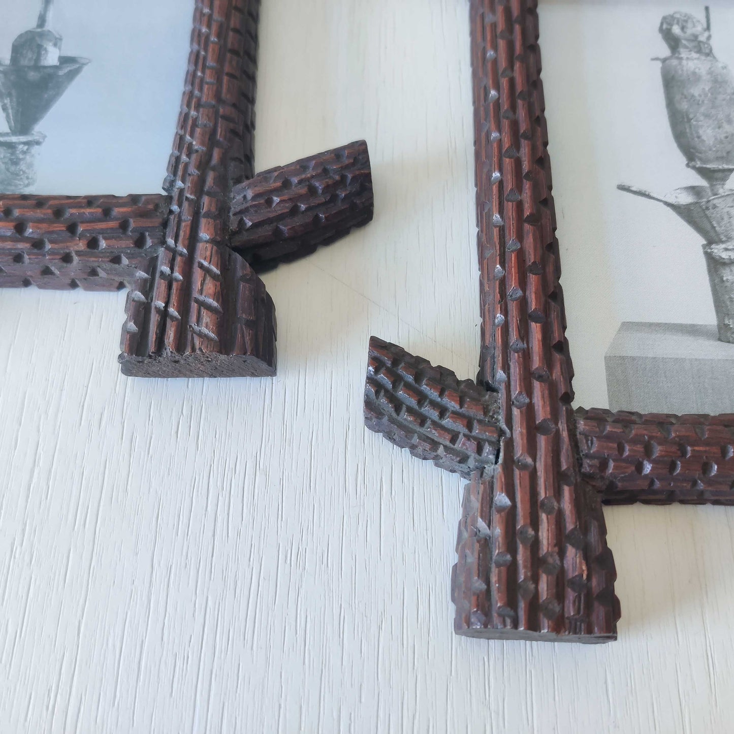 A pair of sculptural tramp folk art notched hand carved oak cross corner frames