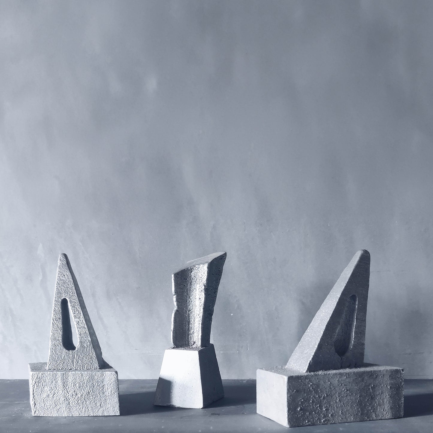 Trio of artist made abstract cast aluminium sculptures