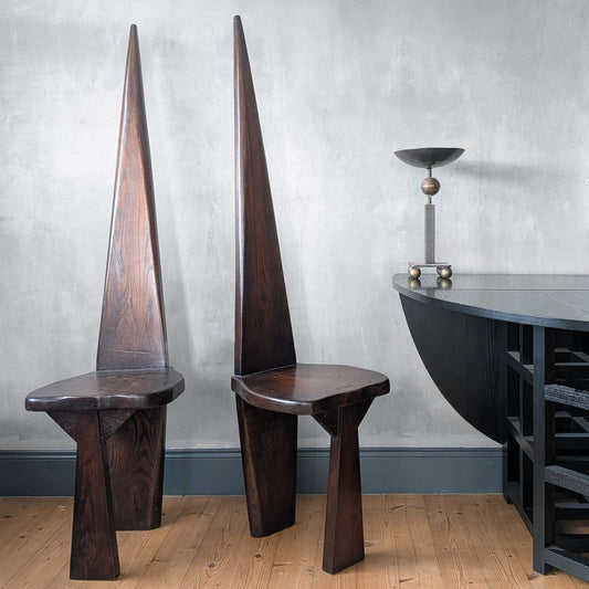 A pair of brutalist sculptural obelisk high back elm chairs