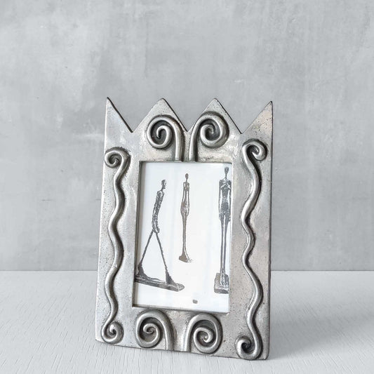 An early 1990s Carrol Boyes sculptural cast pewter photo frame with scroll reliefs