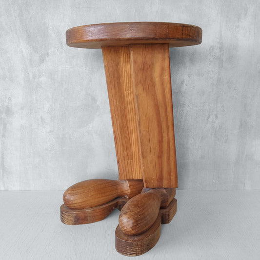 A 1980s postmodern pop art revival pine stool or plinth with booted feet