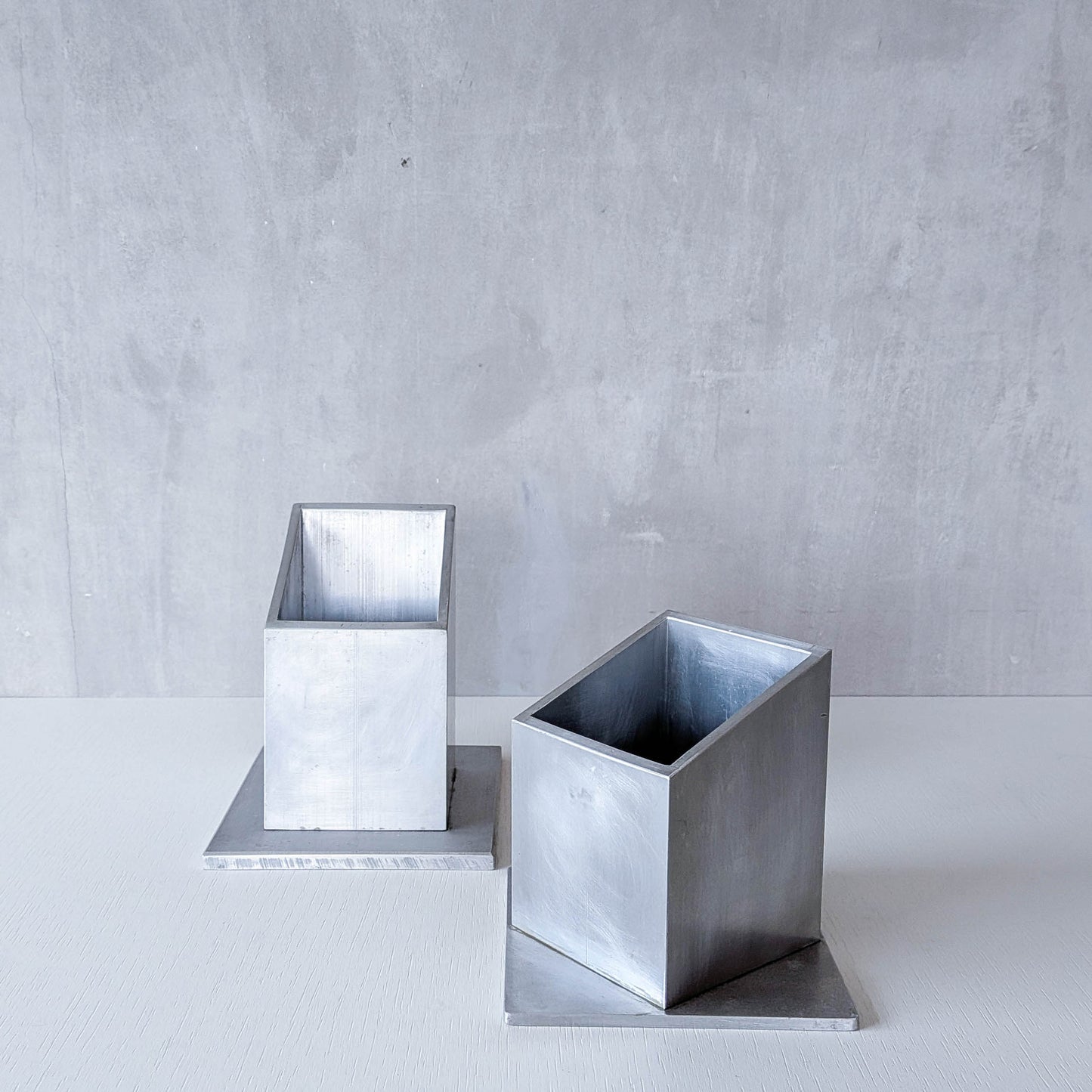 Pair of vintage scratch built sculptural aluminium desk tidy pen holders